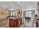 Open-concept kitchen featuring an island, stainless steel appliances, and views into the living and dining areas at 892 High Point Trl, Elizabeth, CO 80107