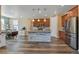 Kitchen area features stainless steel appliances, central island, and an open floor plan to a dining area at 892 High Point Trl, Elizabeth, CO 80107