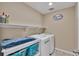 Convenient laundry room with appliances and storage for efficient chores at 892 High Point Trl, Elizabeth, CO 80107