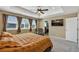 Inviting main bedroom with ceiling fan, TV and large windows at 892 High Point Trl, Elizabeth, CO 80107