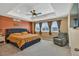 Relaxing main bedroom featuring a tray ceiling, plush carpet, and ample natural light at 892 High Point Trl, Elizabeth, CO 80107