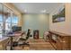 Bright home office featuring a large window, modern desk, and ample storage space with barn door details at 892 High Point Trl, Elizabeth, CO 80107