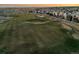 Scenic aerial view of a lush green golf course surrounded by residential homes and a walking path at 1609 S Catawba Cir, Aurora, CO 80018