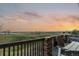 Inviting deck area features outdoor furniture and grill, offering panoramic sunset views at 1609 S Catawba Cir, Aurora, CO 80018