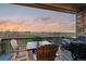 Charming outdoor deck with dining set and grill, overlooking scenic views, perfect for entertaining at 1609 S Catawba Cir, Aurora, CO 80018