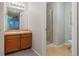 Bathroom featuring neutral walls, wood cabinets, and tile flooring leading to the separate toilet area and standing shower at 1609 S Catawba Cir, Aurora, CO 80018