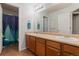 Bathroom featuring neutral walls, wood cabinets with double sinks, and tile flooring at 1609 S Catawba Cir, Aurora, CO 80018