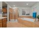 View of bathroom showcasing the bathtub, separate shower with glass door, tile flooring, and a large window at 1609 S Catawba Cir, Aurora, CO 80018