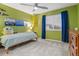 Bedroom with green walls, natural light, a ceiling fan, and cozy decor creates an inviting and fun space at 1609 S Catawba Cir, Aurora, CO 80018