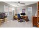 Bedroom with neutral walls showcasing a chair, lamp, desk, and a window with natural light at 1609 S Catawba Cir, Aurora, CO 80018