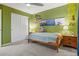 Bedroom with green walls featuring carpet, closet, and natural lighting at 1609 S Catawba Cir, Aurora, CO 80018