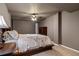 Well-lit bedroom with neutral walls, ceiling fan, and carpeted floors, perfect for restful nights at 1609 S Catawba Cir, Aurora, CO 80018
