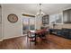 Well-lit dining area with hardwood floors, modern lighting, and sliding glass doors to the outside at 1609 S Catawba Cir, Aurora, CO 80018