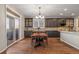 Bright dining room with dark wood cabinets, a sliding glass door to a patio, and hardwood floors at 1609 S Catawba Cir, Aurora, CO 80018