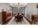 Formal dining room featuring a tray ceiling, large window, hardwood floors, and elegant decor at 1609 S Catawba Cir, Aurora, CO 80018