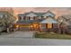 Charming two-story home with a brick and siding facade, garage, and well-manicured lawn at sunset at 1609 S Catawba Cir, Aurora, CO 80018