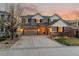 Charming two-story home with a brick and siding facade, garage, and well-manicured lawn at sunset at 1609 S Catawba Cir, Aurora, CO 80018