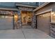Two-car garage and brick entryway of a well-maintained home with exterior lighting and concrete driveway at 1609 S Catawba Cir, Aurora, CO 80018