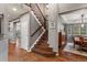 Elegant foyer featuring hardwood floors, wooden staircase and neutral color palette at 1609 S Catawba Cir, Aurora, CO 80018
