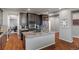 Granite counters with stainless steel appliances and wooden floors are featured in this open concept kitchen at 1609 S Catawba Cir, Aurora, CO 80018