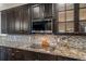 This kitchen features granite countertops, tile backsplash and stainless steel appliances at 1609 S Catawba Cir, Aurora, CO 80018