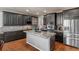 Modern kitchen with stainless steel appliances, granite counters, and dark wood cabinets at 1609 S Catawba Cir, Aurora, CO 80018