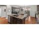 Stylish kitchen island featuring granite countertops and stainless steel appliances with an open concept view at 1609 S Catawba Cir, Aurora, CO 80018