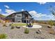 Lovely backyard featuring a small lawn, stone landscaping, concrete patio, and second story covered deck at 4745 Mesa Top Dr, Monument, CO 80132