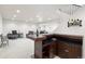 Finished basement bar area complete with custom cabinets, sink, wine rack, and seating space at 4745 Mesa Top Dr, Monument, CO 80132
