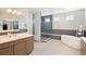 Modern bathroom featuring a soaking tub, glass shower, and double vanities at 4745 Mesa Top Dr, Monument, CO 80132