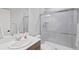 Bright bathroom featuring a glass-enclosed shower with tile surround, modern fixtures, and white vanity at 4745 Mesa Top Dr, Monument, CO 80132