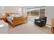 Bedroom with a large window offering scenic mountain views at 4745 Mesa Top Dr, Monument, CO 80132