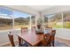 Dining room with views of the mountains and a wooden dining table with seating for six at 4745 Mesa Top Dr, Monument, CO 80132