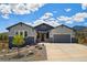 Beautiful two-tone home with an attached garage and landscaped front yard and mountain views at 4745 Mesa Top Dr, Monument, CO 80132