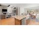 Modern kitchen with granite countertops, farmhouse sink, and a view to the living and dining rooms at 4745 Mesa Top Dr, Monument, CO 80132