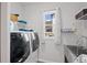 Laundry room with shelving, washer, dryer, a utility sink and outside views at 4745 Mesa Top Dr, Monument, CO 80132