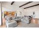 Open-concept living room with a large sectional sofa and a view to the kitchen and foyer at 4745 Mesa Top Dr, Monument, CO 80132