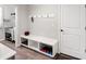 Mud room with a bench, hooks, door, and tile flooring near sink at 4745 Mesa Top Dr, Monument, CO 80132