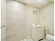 Basement bathroom with a white vanity and tiled shower at 8501 E 104Th Ave, Henderson, CO 80640