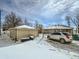 Detached garage in the backyard with snow on the ground at 8501 E 104Th Ave, Henderson, CO 80640