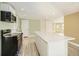 Kitchen island with white countertop, green walls at 8501 E 104Th Ave, Henderson, CO 80640