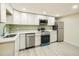 Modern kitchen with white cabinets and stainless steel appliances at 8501 E 104Th Ave, Henderson, CO 80640