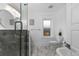 Elegant bathroom with marble tile, soaking tub, and walk-in shower at 3347 Federal Blvd, Denver, CO 80211