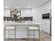 Bright kitchen with white cabinets, quartz counters, and island seating at 3347 Federal Blvd, Denver, CO 80211