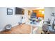 Comfortable home office with wood floors, a monitor, and a view of the living room at 1155 N Ash St # 806, Denver, CO 80220