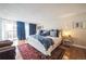 Beautiful bedroom features hardwood floors, comfortable bed, and sliding glass door to balcony at 1155 N Ash St # 806, Denver, CO 80220