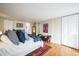 Large bedroom features hardwood floors, comfortable furniture, and access to multiple closets at 1155 N Ash St # 806, Denver, CO 80220
