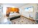 Cozy bedroom featuring hardwood floors, a decorative rug, and ample natural light at 1155 N Ash St # 806, Denver, CO 80220