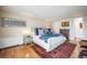 Elegant bedroom with hardwood floors, a well-dressed bed, and comfortable decor at 1155 N Ash St # 806, Denver, CO 80220