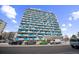 Modern condo building with blue accents and ample parking at 1155 N Ash St # 806, Denver, CO 80220